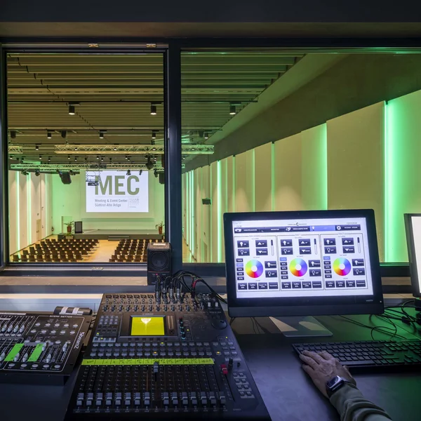 Audio and lighting control room with screens and mixer at MEC Meeting & Event Center